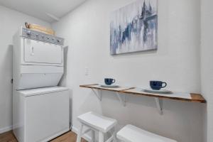 a kitchen with a refrigerator and two cups on a counter at Le Petite Willow - Guesthouse in Modesto +7 photos