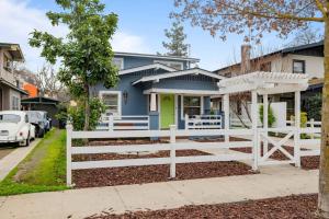 a house with a white fence in front of it at Le Petite Willow - Guesthouse in Modesto