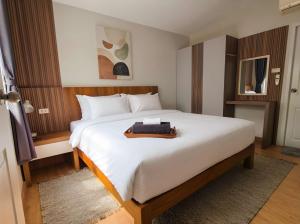 a bedroom with a large white bed with a tray on it at Zen Ocean Villa -Sri Thanu in Ko Phangan