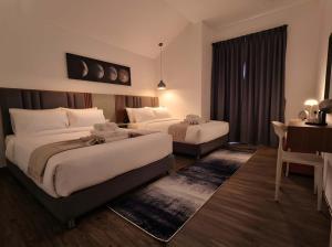 a hotel room with two beds and a desk at Zen Ocean Villa -Sri Thanu in Ko Phangan +4 photos
