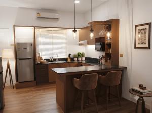 a kitchen with a large island with two bar stools at Zen Ocean Villa -Sri Thanu in Ko Phangan