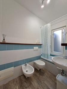 a bathroom with a toilet and a sink at Casa del Sole Guest Rooms in Alghero