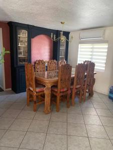 a dining room with a wooden table and chairs at Naya homes: The estero beach. in Ensenada