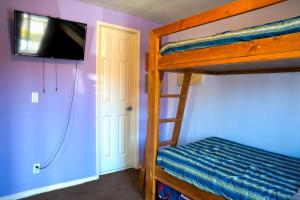 a bedroom with a bunk bed with a flat screen tv at Naya homes: The estero beach. in Ensenada +22 photos