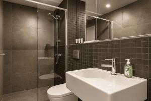 a bathroom with a sink and a toilet and a mirror at Lakeview on Grazier in Belconnen +9 photos