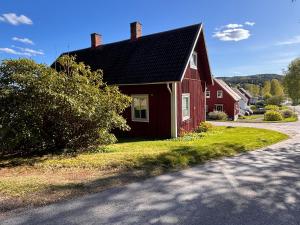 a red house sitting on the side of a road at StayinDalsland in Dals Långed