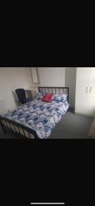 a bedroom with a bed with a red pillow on it at Central stay in Nottingham