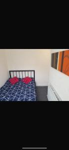 a bedroom with a bed with two red pillows on it at Central stay in Nottingham +4 photos
