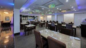 a dining room with tables and chairs and purple lighting at Western Downs Motor Inn in Miles
