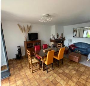 a living room with a table and chairs and a couch at Maison rurale 8 personnes in Saint-Hilaire-de-Court