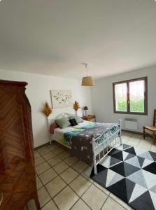 a bedroom with a bed and a checkered floor at Maison rurale 8 personnes in Saint-Hilaire-de-Court +6 photos