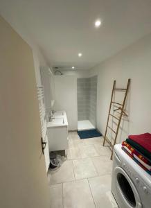 a bathroom with a sink and a washing machine at Maison rurale 8 personnes in Saint-Hilaire-de-Court