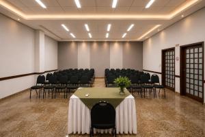 a conference room with chairs and a table in it at Cedro Hotel in Londrina
