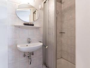 a bathroom with a sink and a shower with a mirror at Grünbichel Hof I in Uttendorf +26 photos