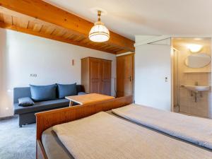 a living room with two beds and a couch at Grünbichel Hof II in Uttendorf