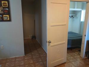 a door leading into a room with a bedroom at Nice Guest House in Artesia +3 photos