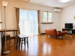 an empty living room with a table and a chair at しまなみ海道-愛犬と泊まれる一棟貸し-本格バレルサウナ-ドッグラン-BBQ完備-YOSHIUMi in Imabari