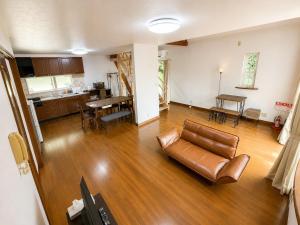 an empty living room with a couch and a table at しまなみ海道-愛犬と泊まれる一棟貸し-本格バレルサウナ-ドッグラン-BBQ完備-YOSHIUMi in Imabari