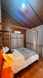 a large bed in a room with a wooden ceiling at Refúgio nas Nuvens Ninho das Águias in Nova Petrópolis