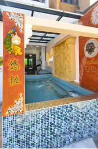 a swimming pool in a house with a tile wall at u hend villa in Hengchun South Gate