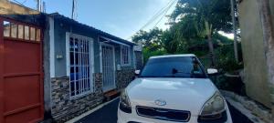 a white car parked in front of a building at Hidden House in Santa Ana