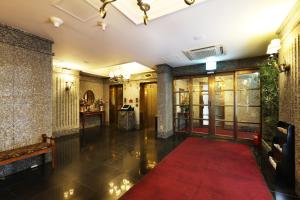 a hallway with a red carpet in a building at Bucheon SR Hotel in Bucheon