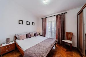 a bedroom with a large bed and a window at Apartments by the sea Brna, Korcula - 561 in Smokvica