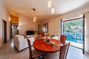 a dining room with a table and a living room at Apartments by the sea Brna, Korcula - 561 in Smokvica