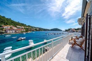 a balcony with a view of a body of water with boats at Apartments by the sea Brna, Korcula - 561 in Smokvica