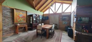 a dining room with a wooden table and chairs at Alojamiento Casa Guadalupe in San Felipe