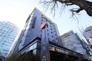 a tall building with a sign in front of it at Bucheon SR Hotel in Bucheon