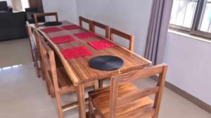 a wooden table with chairs and a tableasteryasteryasteryasteryasteryasteryasteryastery at Paradise Pacifica in Pacific Harbour