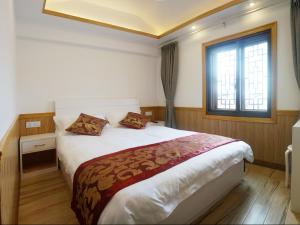 Voodi või voodid majutusasutuse Wuzhen On Memory Inn toas