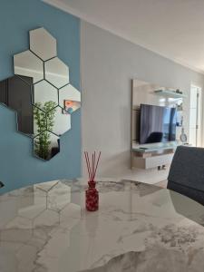 a living room with a vase sitting on a table at Ellipse Waterfall - The Oasis Luxury Stay in Midrand