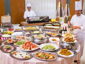 two chefs standing in front of a buffet of food at Washigatake Kogen Hotel Rainbow in Gujo