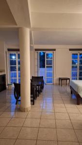 a room with benches and a bed and windows at Los Pueblitos de Guanajuato in Guanajuato