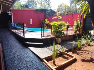 a swimming pool in a yard with plants at JM Resort Iguazu in Puerto Iguazú