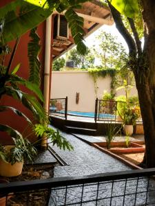 a courtyard of a building with plants and a fence at JM Resort Iguazu in Puerto Iguazú
