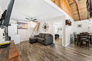 a living room with a couch and a table at Delightful Cabin Loft Fire Pit & BBQ Julian in Julian
