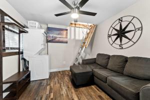 a living room with a couch and a ceiling fan at Delightful Cabin Loft Fire Pit & BBQ Julian in Julian