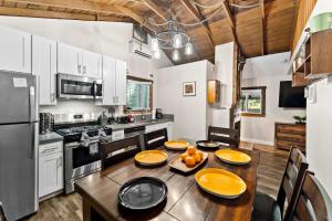 a kitchen with a table with oranges on it at Delightful Cabin Loft Fire Pit & BBQ Julian in Julian +29 photos