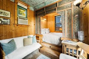 a bedroom with two beds in a wooden room at Escape to Rustic Studio Fireplace Modern Comfort in Julian