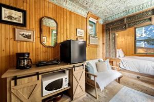 a bedroom with a bed and a tv on a table at Escape to Rustic Studio Fireplace Modern Comfort in Julian +25 photos