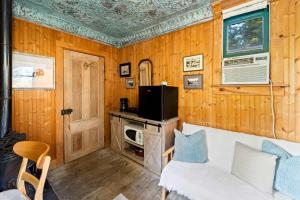 a living room with a white couch and a tv at Escape to Rustic Studio Fireplace Modern Comfort in Julian