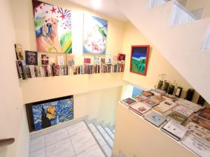 a room with a counter with paintings and books at Apartamentos Pachatusan in Pisac