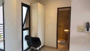 a black chair in a room with a bathroom at "REFUGIO EN LA TERRAZA" - WiFi 300mbs in Santiago del Estero +15 photos