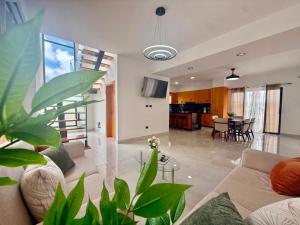 a living room with a couch and a dining room at Paradise Cove in Punta Cana