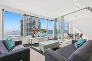 a living room with two couches and a view of the ocean at Q1 Resort & Spa - Official in Gold Coast