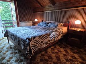 a bedroom with a zebra print bed with two lamps at Villa DORA in Vrbovsko