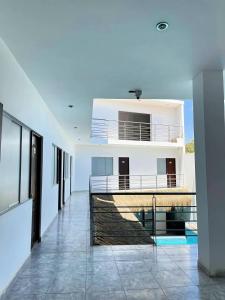 a hallway of a white building with a balcony at Hospedaje Dora in Máncora +3 photos